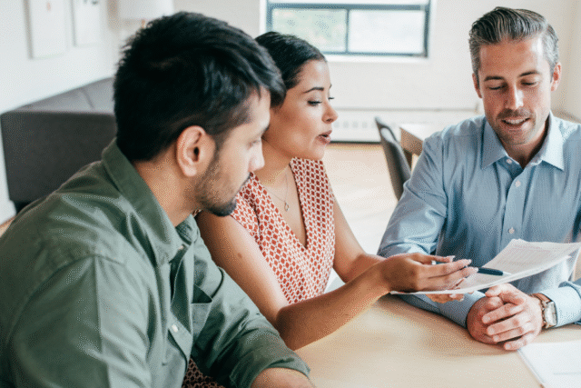 Couple discussing mortgage rates with their loan officer.